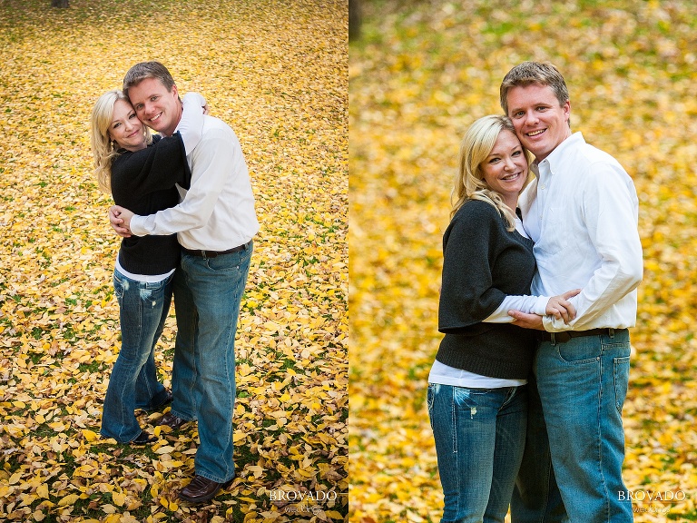 engaged couple holds each other close in the fall