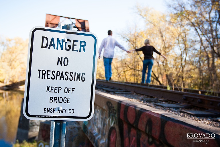 couple walk across railroad tracks