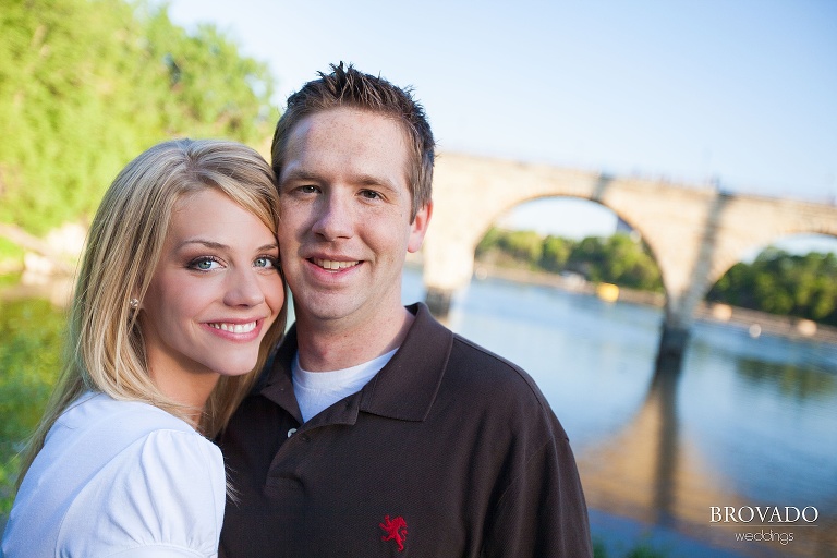 engagement photo of couple smiling in front of mississippi river