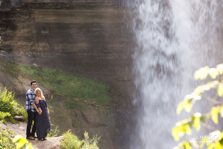Engaged couple posing in front of minnehaha falls